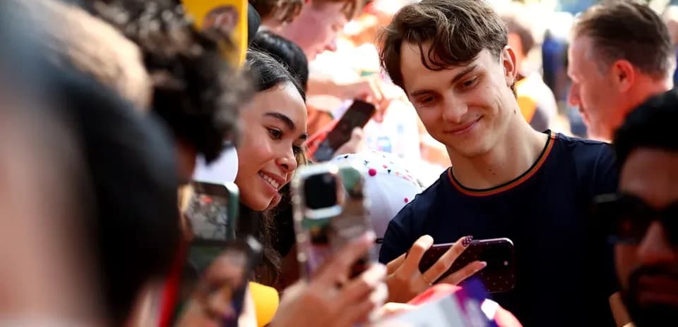 Fans taking selfies with each other at event