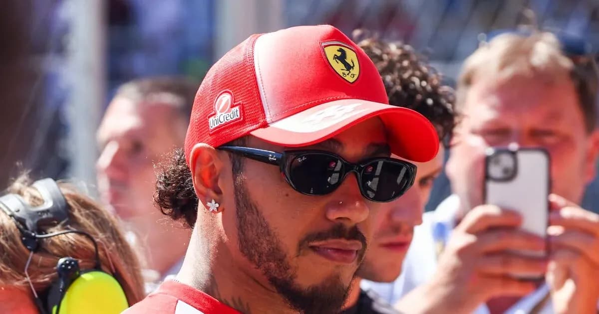 Driver wearing Ferrari cap and sunglasses in crowd