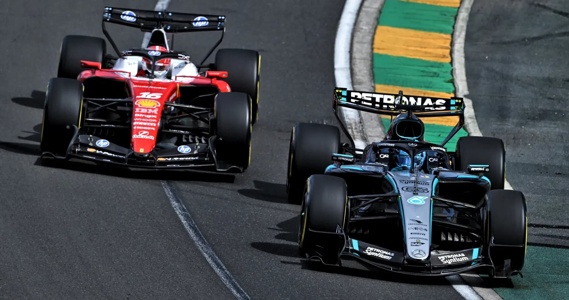 Two Formula 1 cars racing on the track