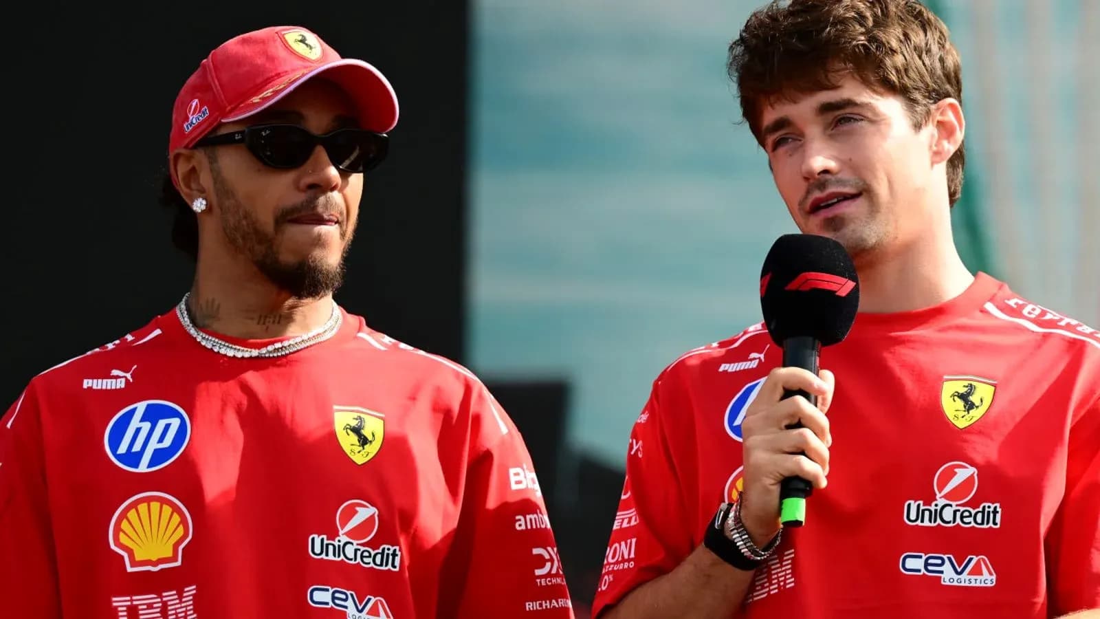 Two drivers speaking at a press event for Ferrari