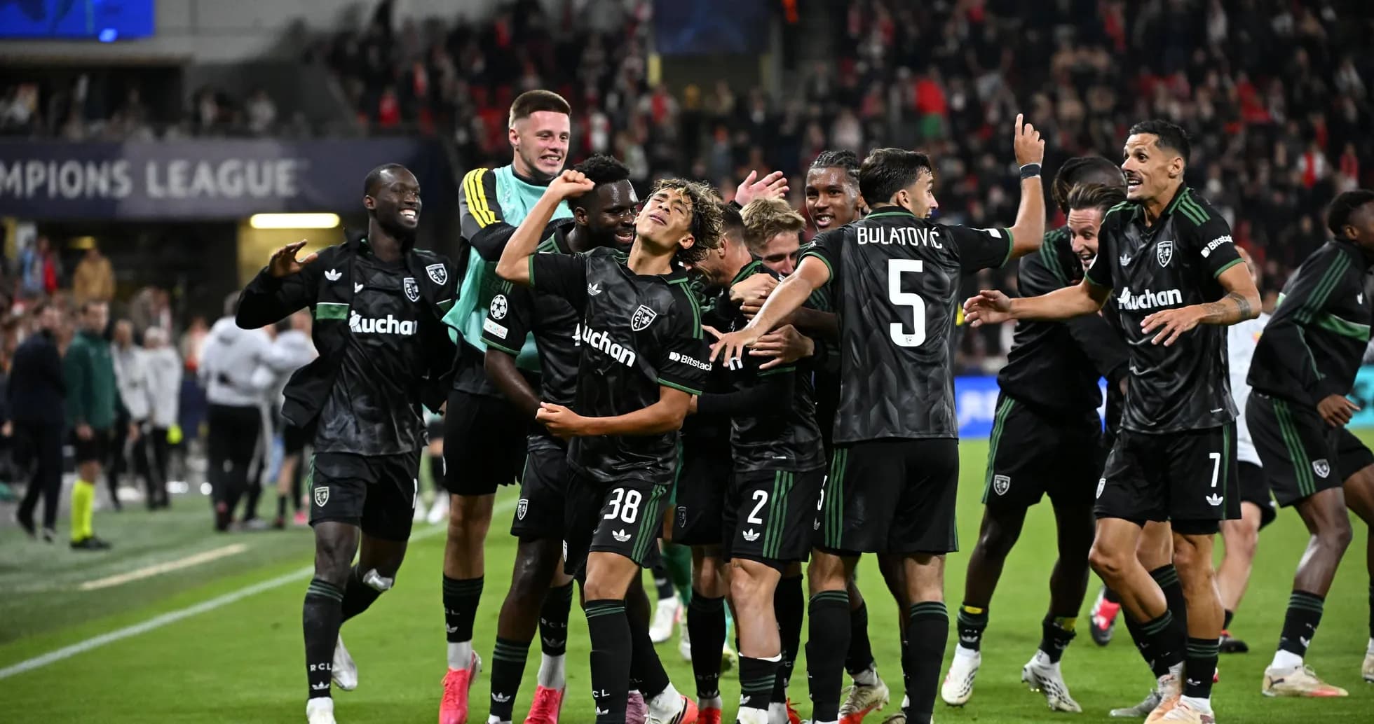 Players celebrating a goal in Champions League match