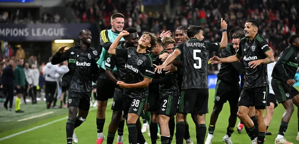 Players celebrating a goal in Champions League match