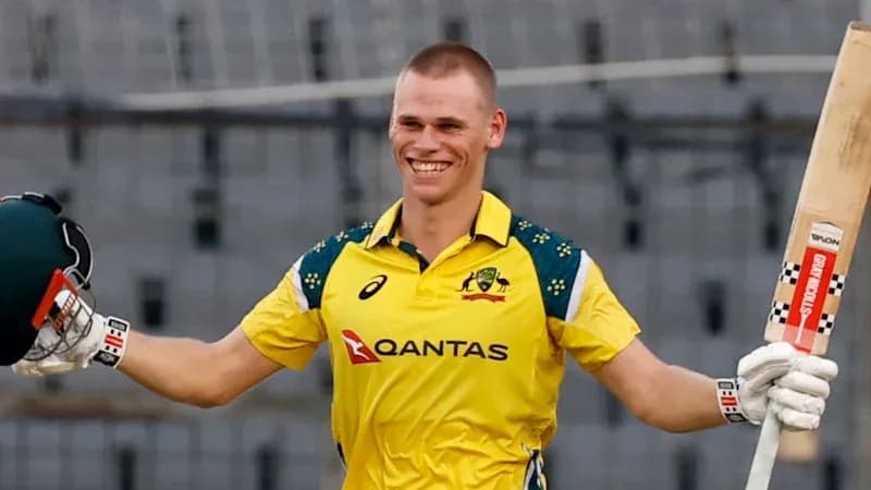 Cricketer celebrating a century in yellow uniform Cricketer celebrating a century in yellow uniform