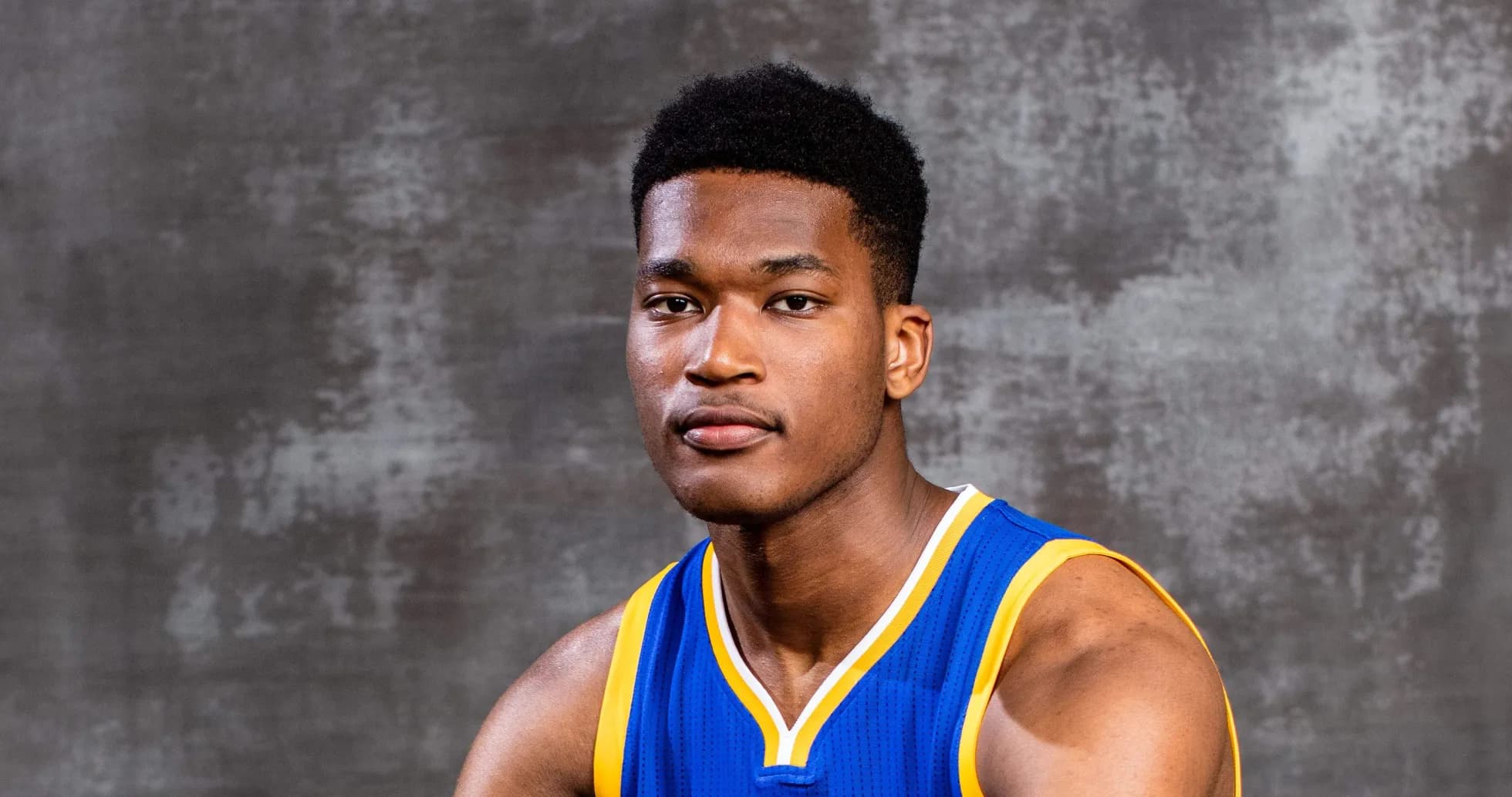 Basketball player in blue jersey posing for photo Basketball player in blue jersey posing for photo