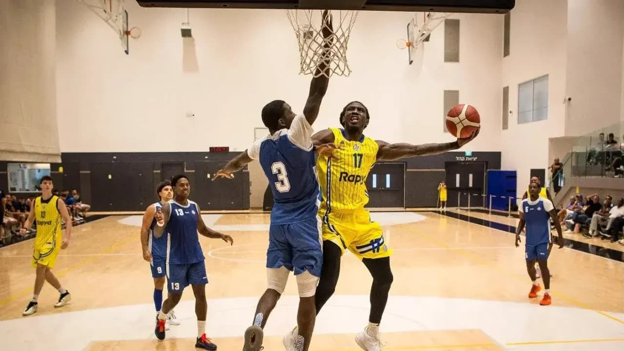 Player dunking the ball during basketball game Player dunking the ball during basketball game