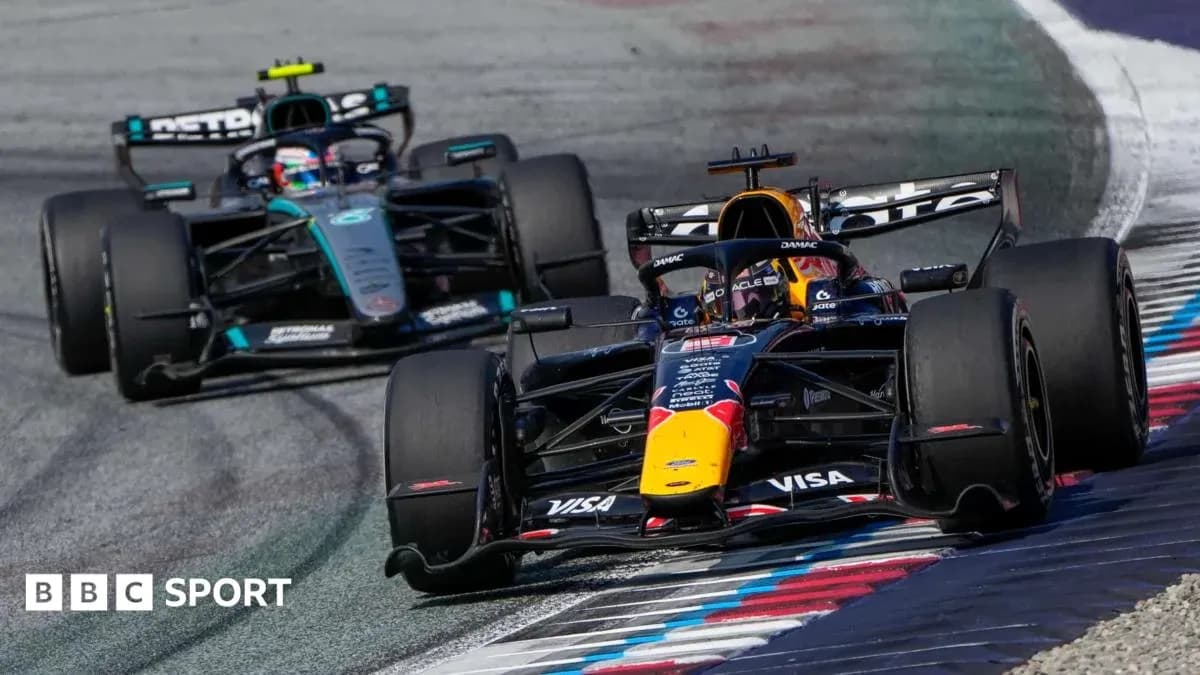 Two Formula 1 cars racing on track Two Formula 1 cars racing on track