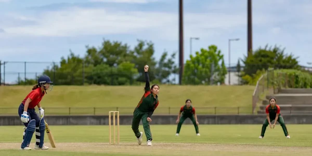 Bowler delivering ball with fielders positioned Bowler delivering ball with fielders positioned