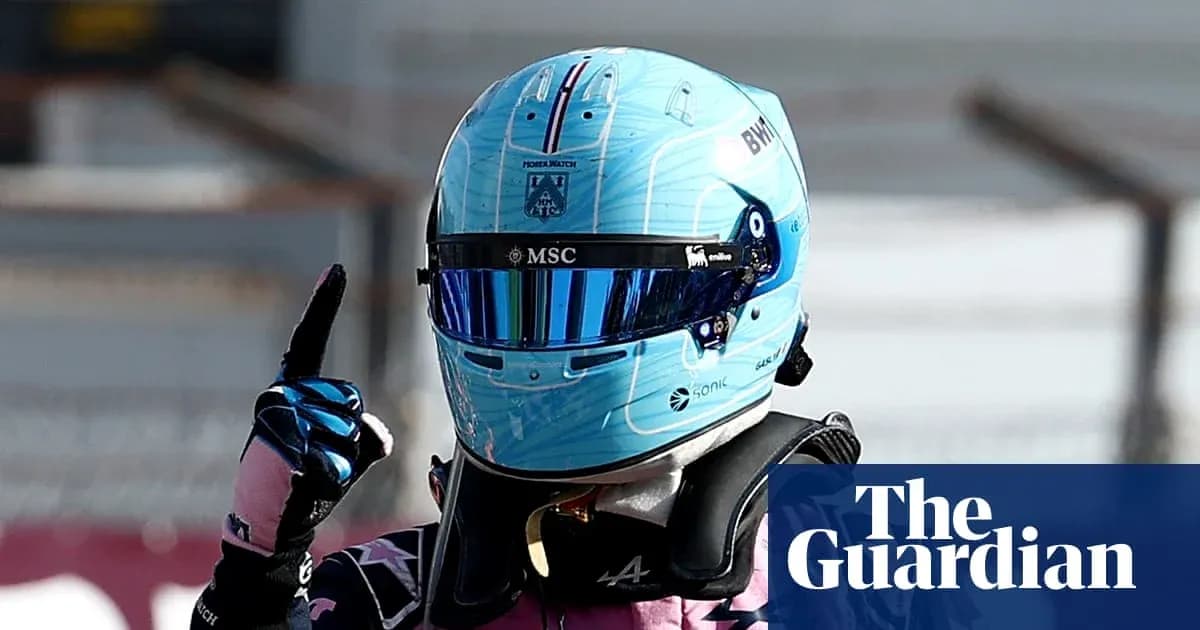 Racing driver celebrating with helmet and gloves raised Racing driver celebrating with helmet and gloves raised