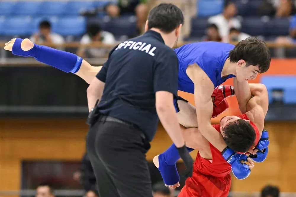 Two fighters competing in a grappling match Two fighters competing in a grappling match