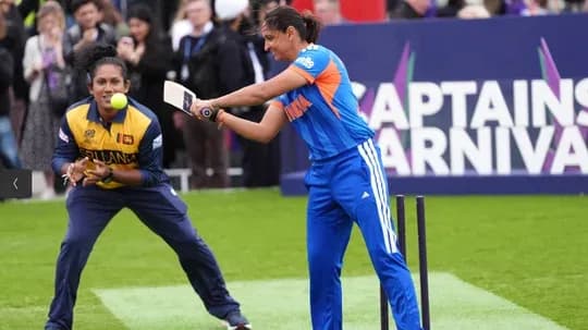 Player batting while wicketkeeper prepares to catch Player batting while wicketkeeper prepares to catch