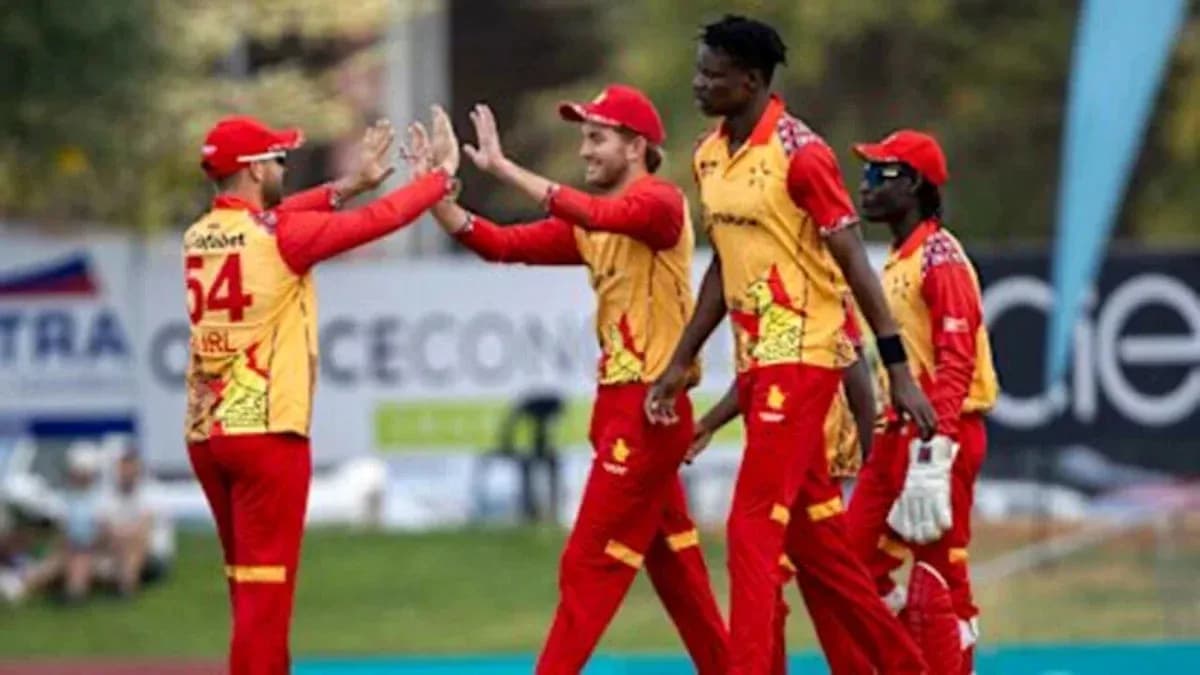 Cricket team celebrating a wicket on field Cricket team celebrating a wicket on field