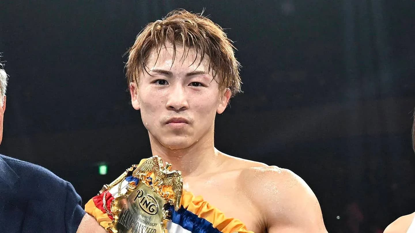 Boxer holding championship belt after victory Boxer holding championship belt after victory