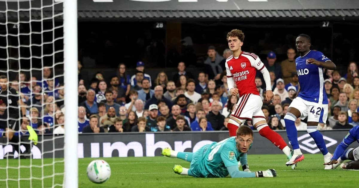 Goalkeeper diving as player scores for Arsenal Goalkeeper diving as player scores for Arsenal