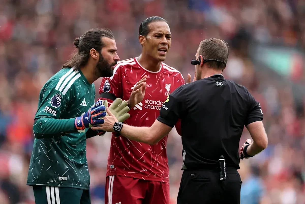 Liverpool players arguing with the referee during match Liverpool players arguing with the referee during match