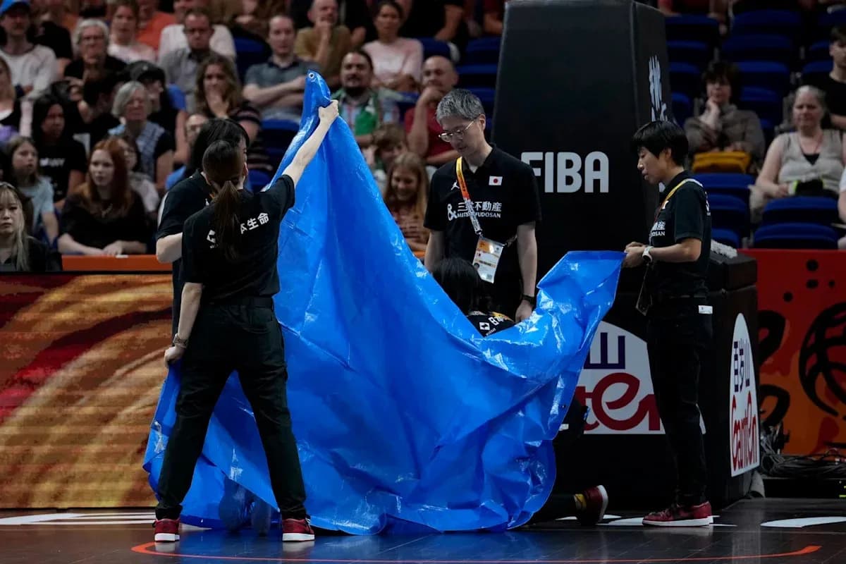 Crew covering the court with a blue tarp Crew covering the court with a blue tarp