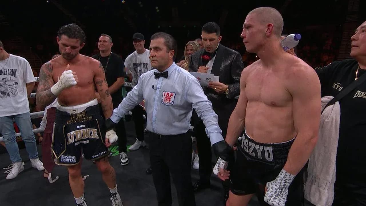 Boxers and referee in the ring after match Boxers and referee in the ring after match