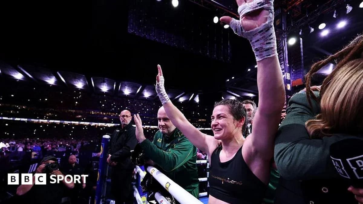 Boxer celebrating victory with raised hands in arena Boxer celebrating victory with raised hands in arena