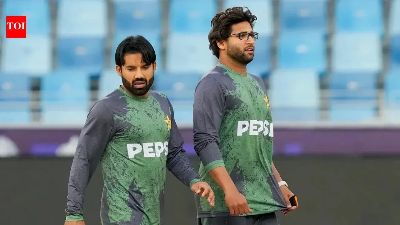 Two cricketers walking on training ground Two cricketers walking on training ground