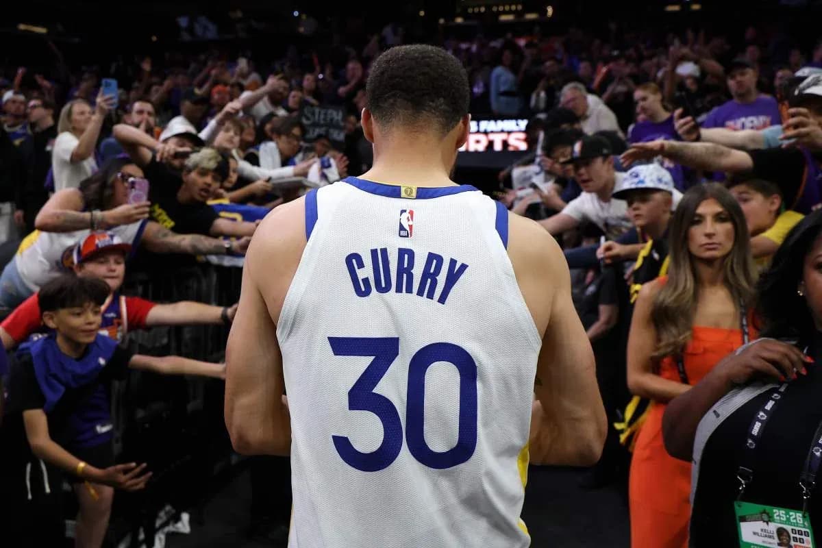 Player wearing jersey surrounded by cheering fans Player wearing jersey surrounded by cheering fans