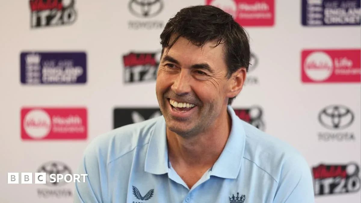 Cricket coach smiling at press conference backdrop Cricket coach smiling at press conference backdrop
