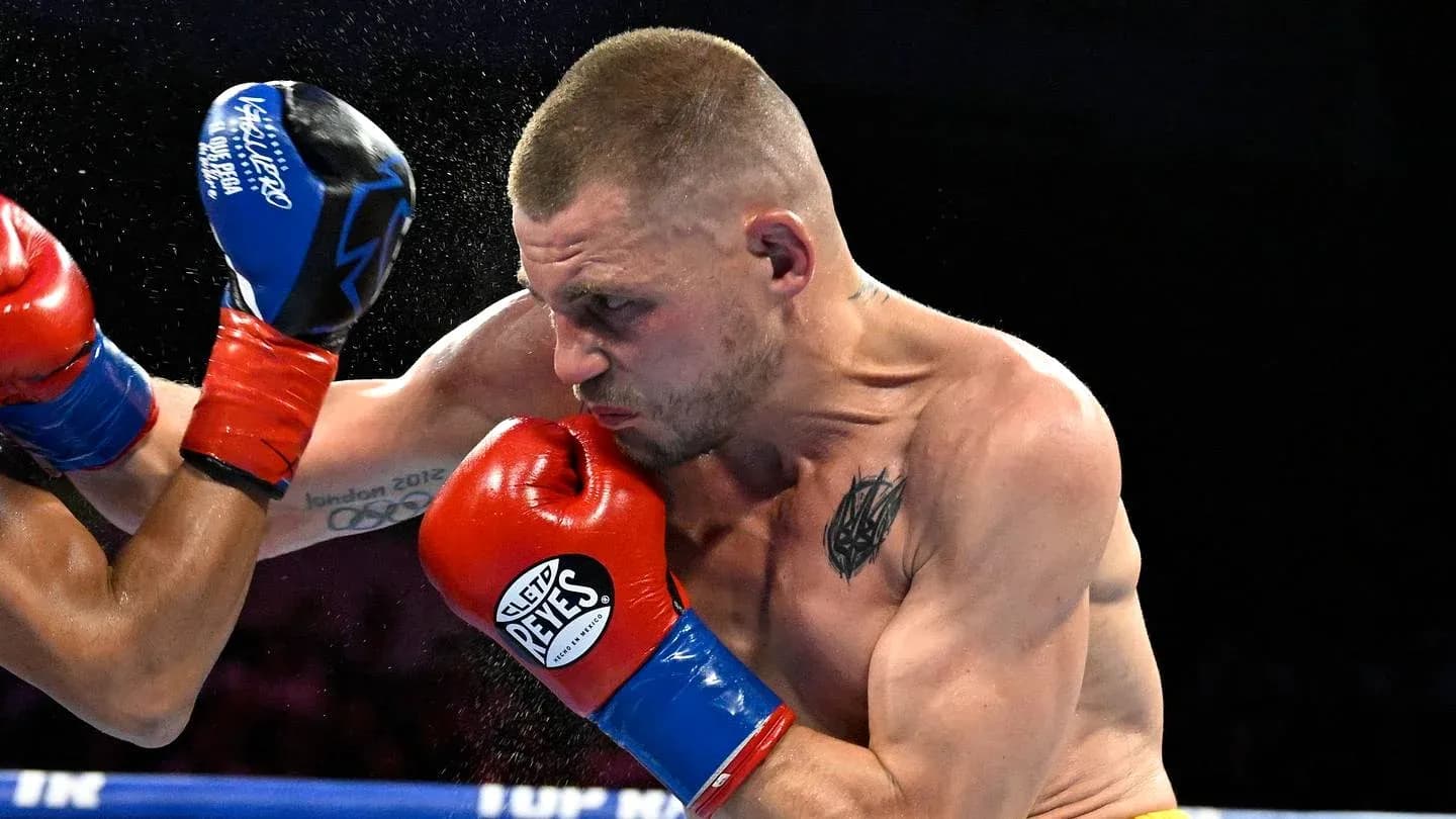 Boxer throwing a punch during a match Boxer throwing a punch during a match
