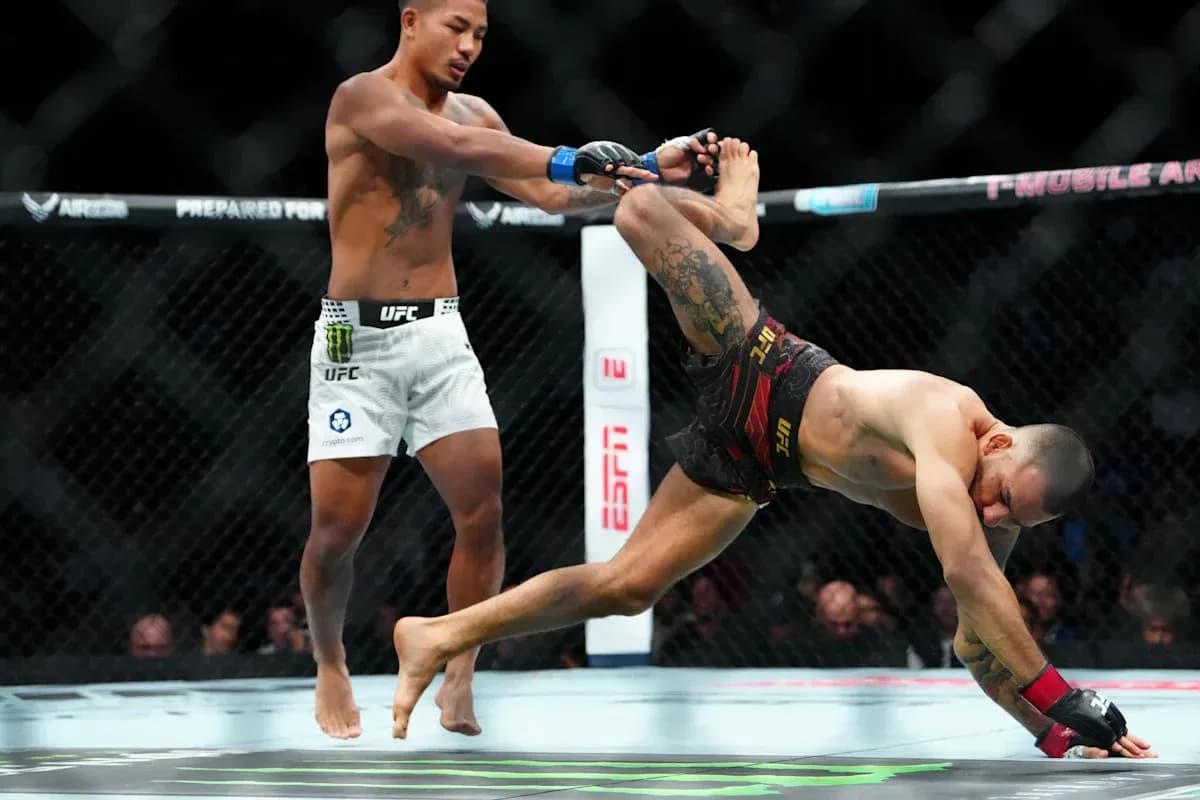 Fighter performing a takedown in UFC match Fighter performing a takedown in UFC match