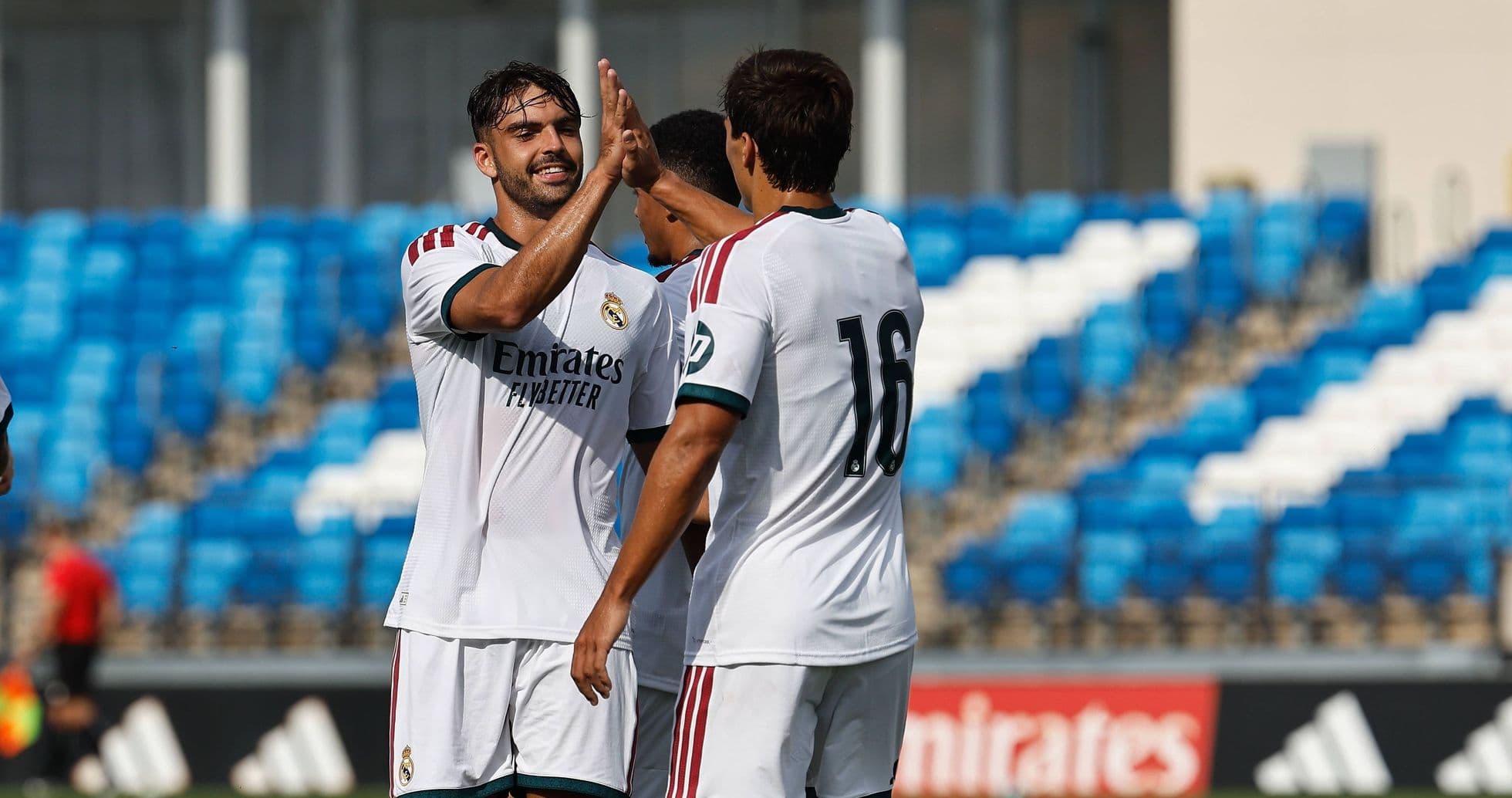 Real Madrid players celebrating a goal on pitch Real Madrid players celebrating a goal on pitch