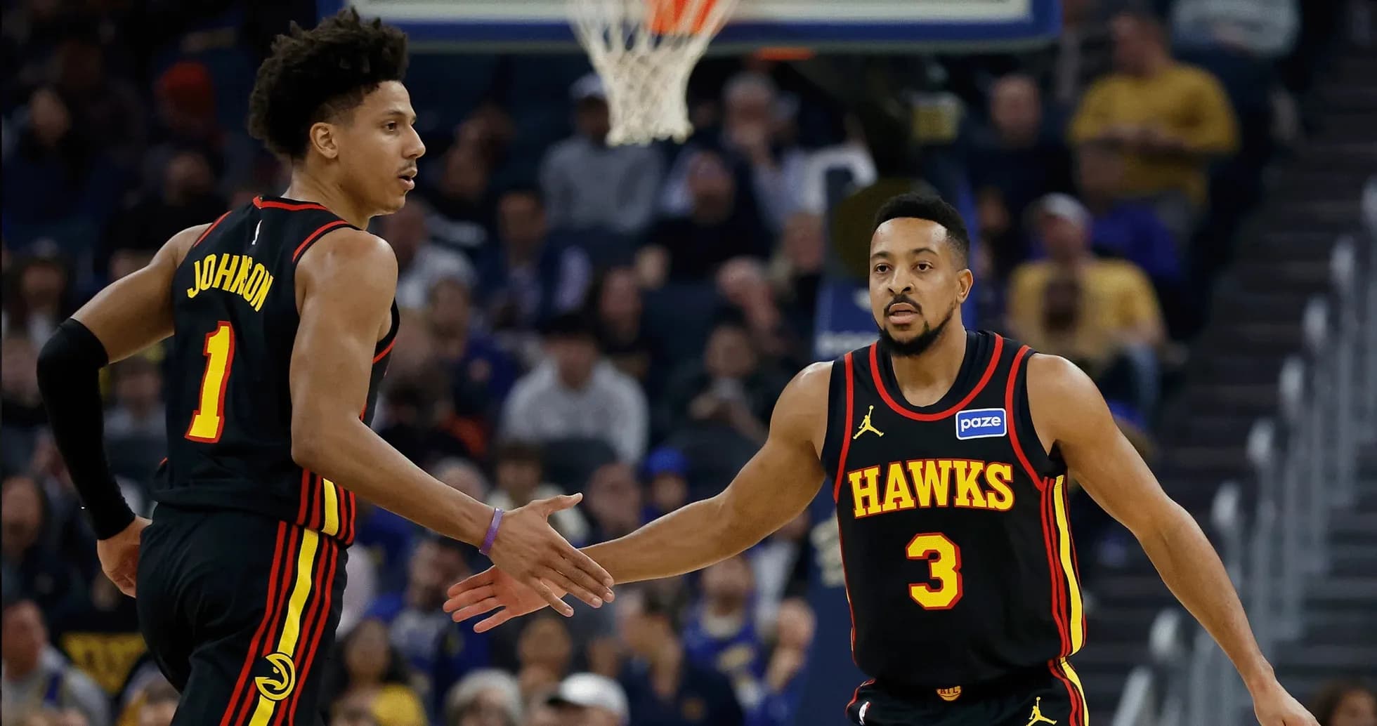 Two Hawks players celebrating during a game Two Hawks players celebrating during a game