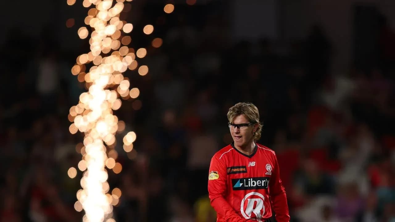 Player in red uniform walking past fireworks display Player in red uniform walking past fireworks display