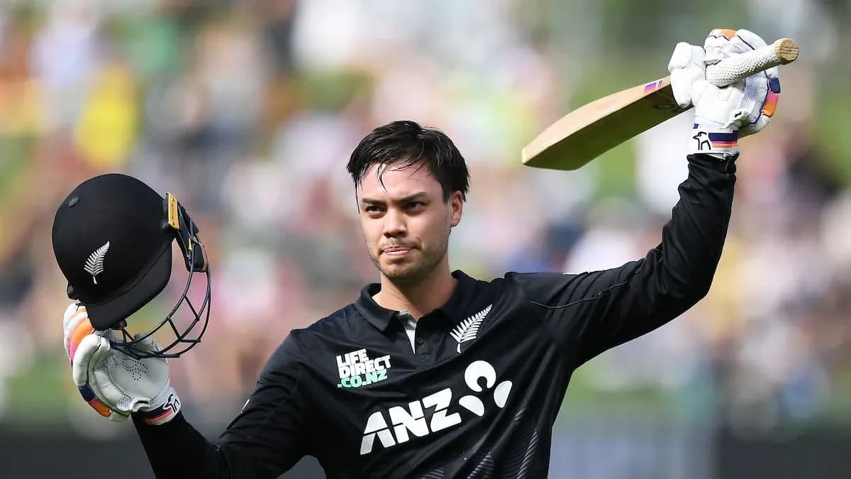 Cricketer celebrating with helmet and bat raised Cricketer celebrating with helmet and bat raised