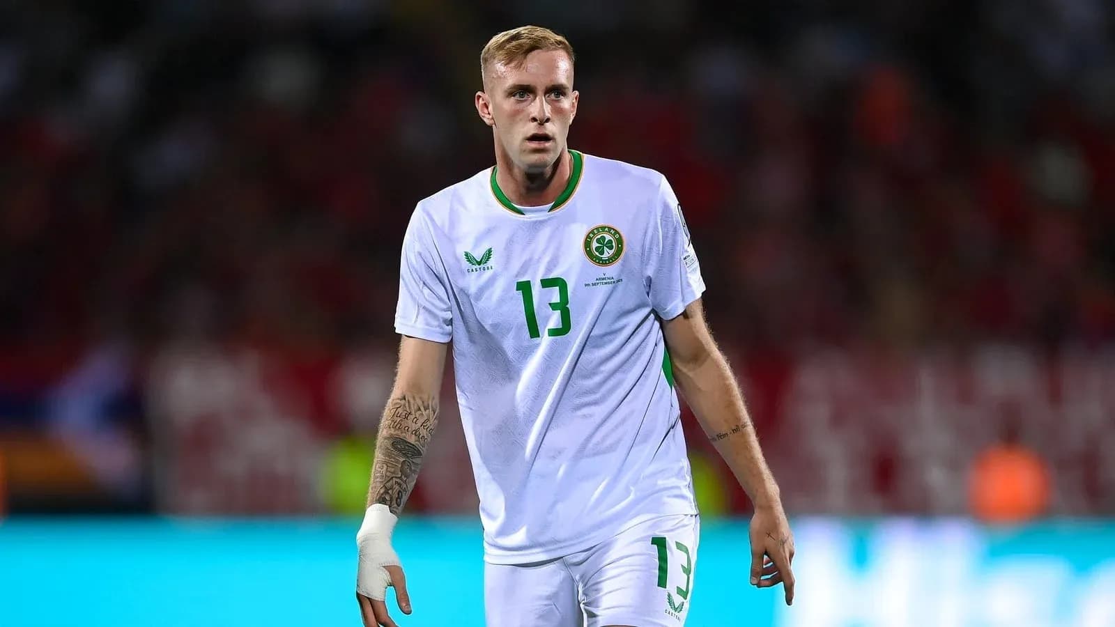Player wearing white jersey with number 13 on pitch Player wearing white jersey with number 13 on pitch