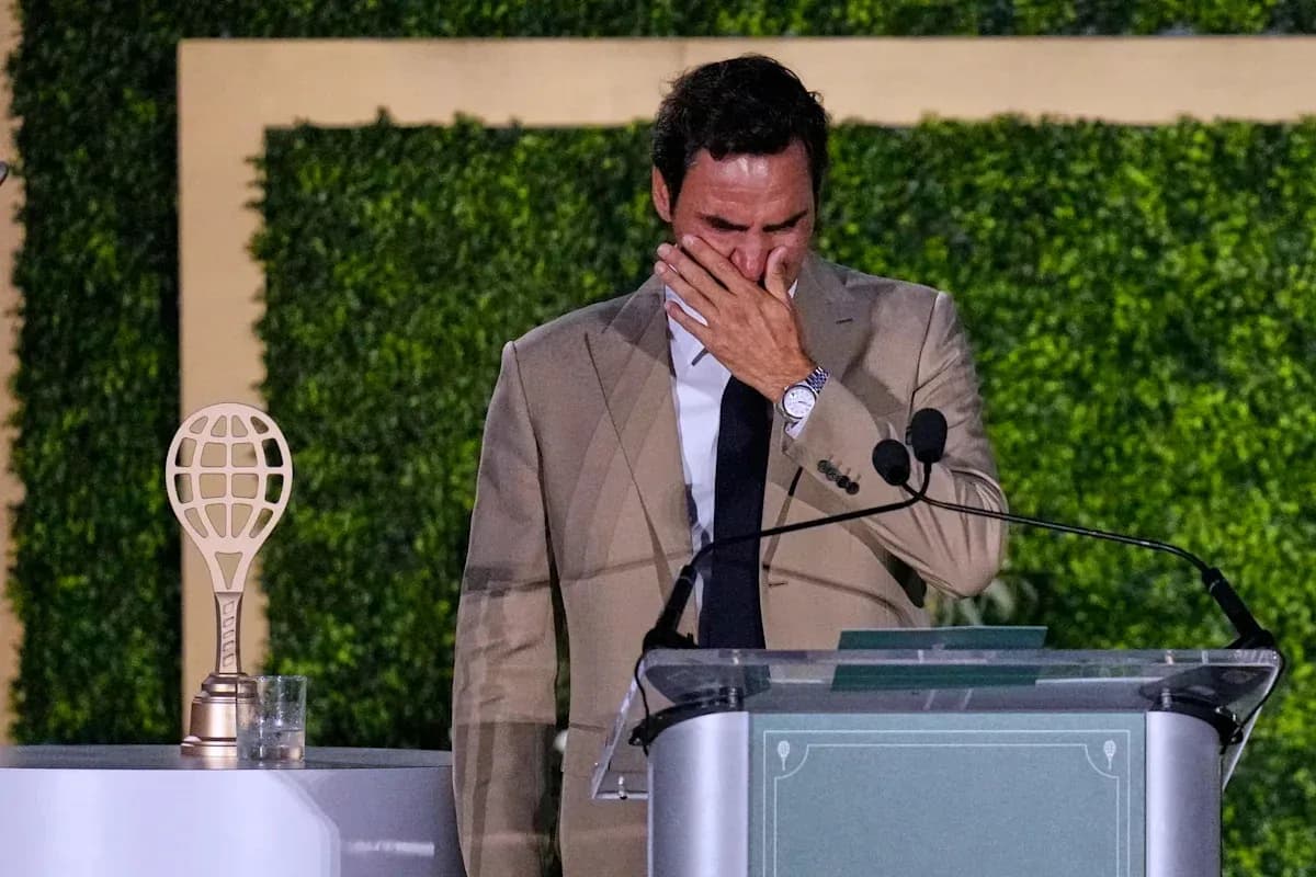 Tennis player at podium with trophy, visibly emotional Tennis player at podium with trophy, visibly emotional