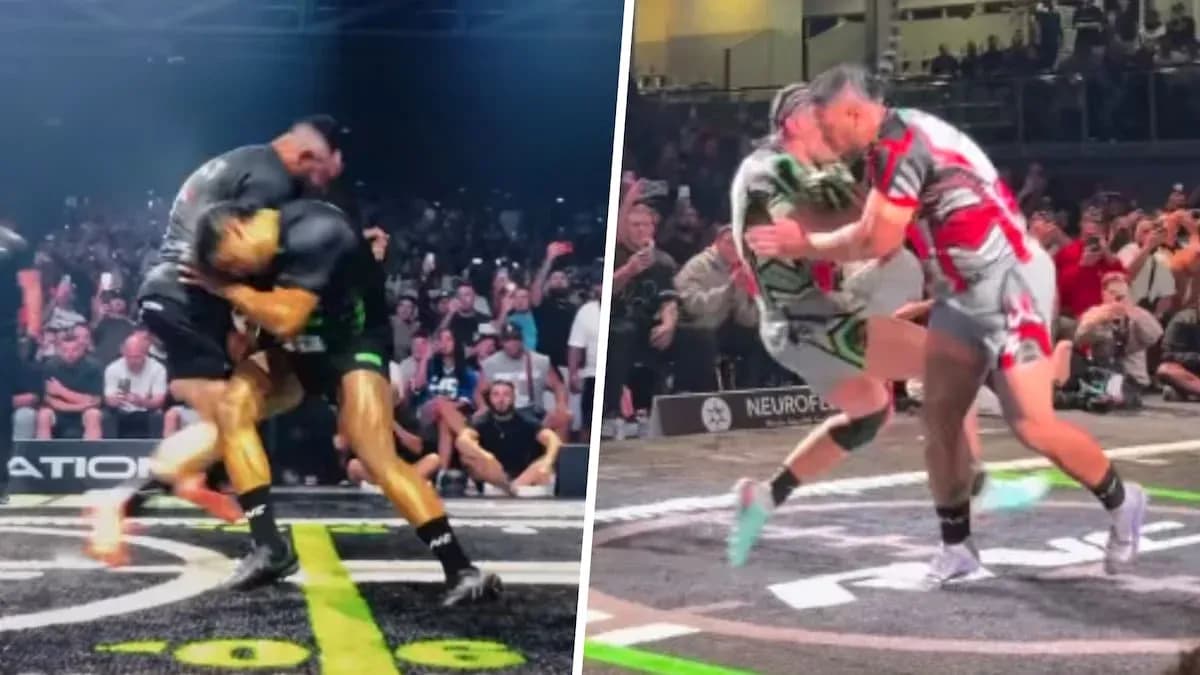 Two wrestlers competing in a match before crowd Two wrestlers competing in a match before crowd