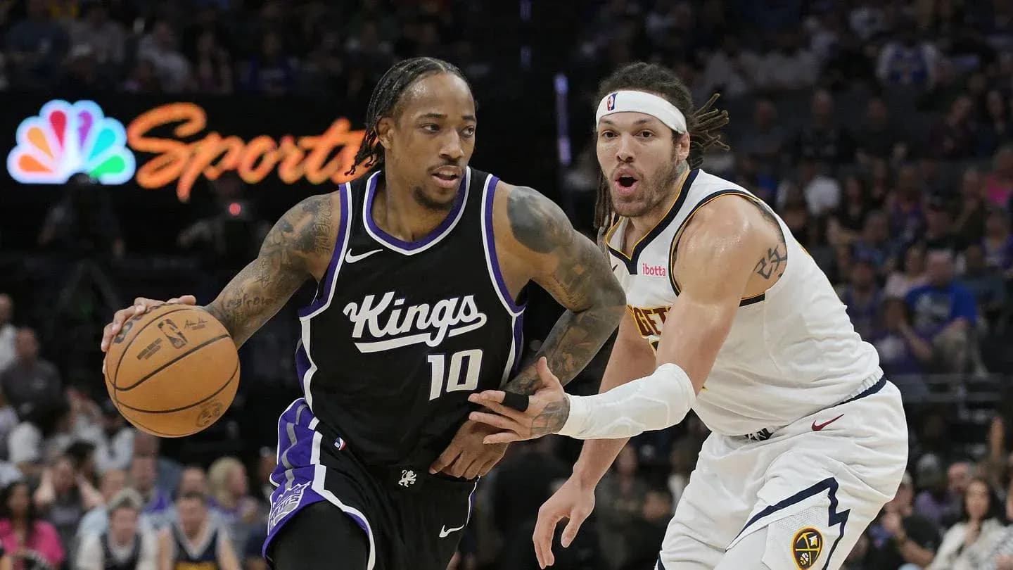 Player dribbling basketball while being closely guarded Player dribbling basketball while being closely guarded