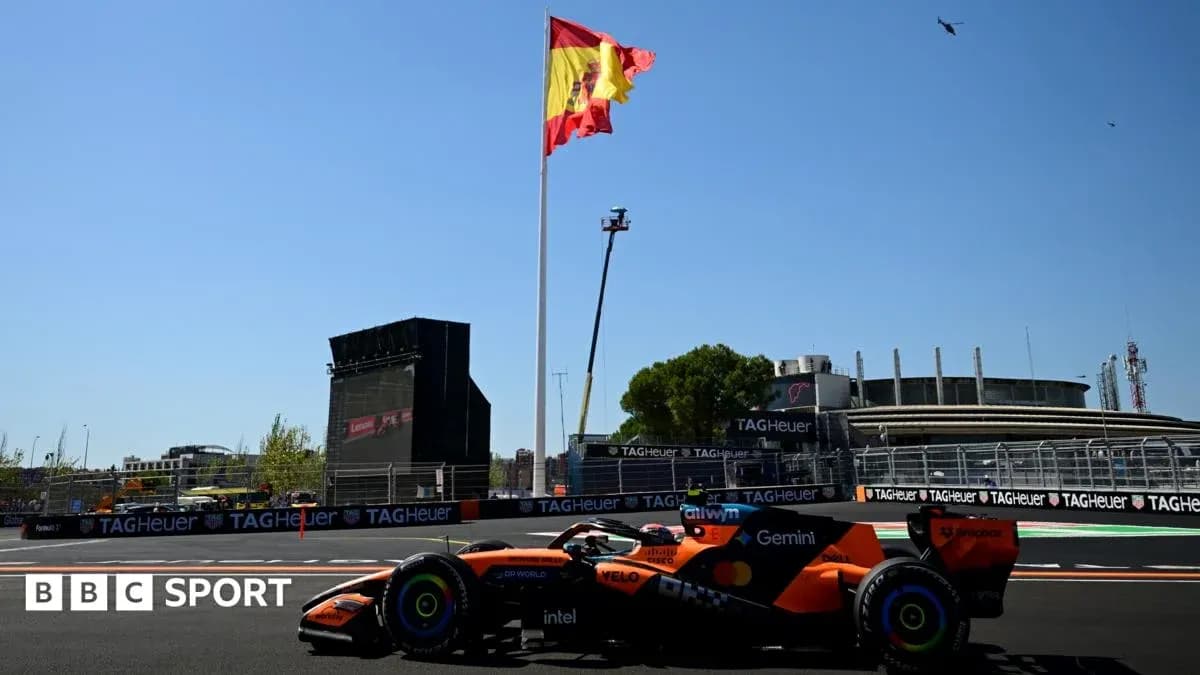 Formula 1 car on track with Spanish flag background Formula 1 car on track with Spanish flag background
