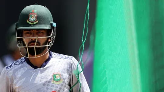 Cricketer wearing helmet walking towards net practice Cricketer wearing helmet walking towards net practice