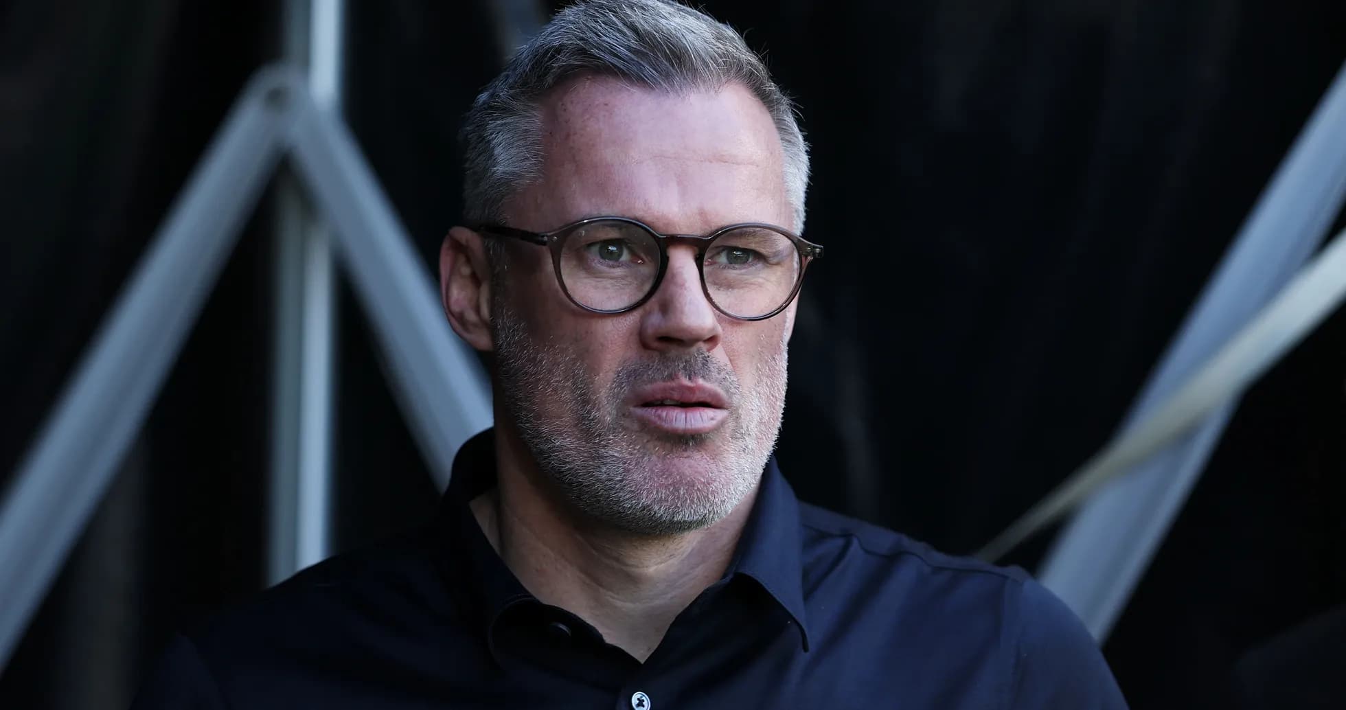 Man with glasses observing from a sports venue Man with glasses observing from a sports venue