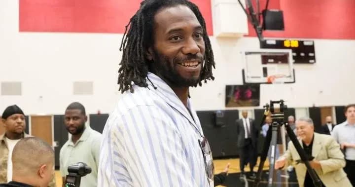 Man smiling during a basketball event or gathering Man smiling during a basketball event or gathering