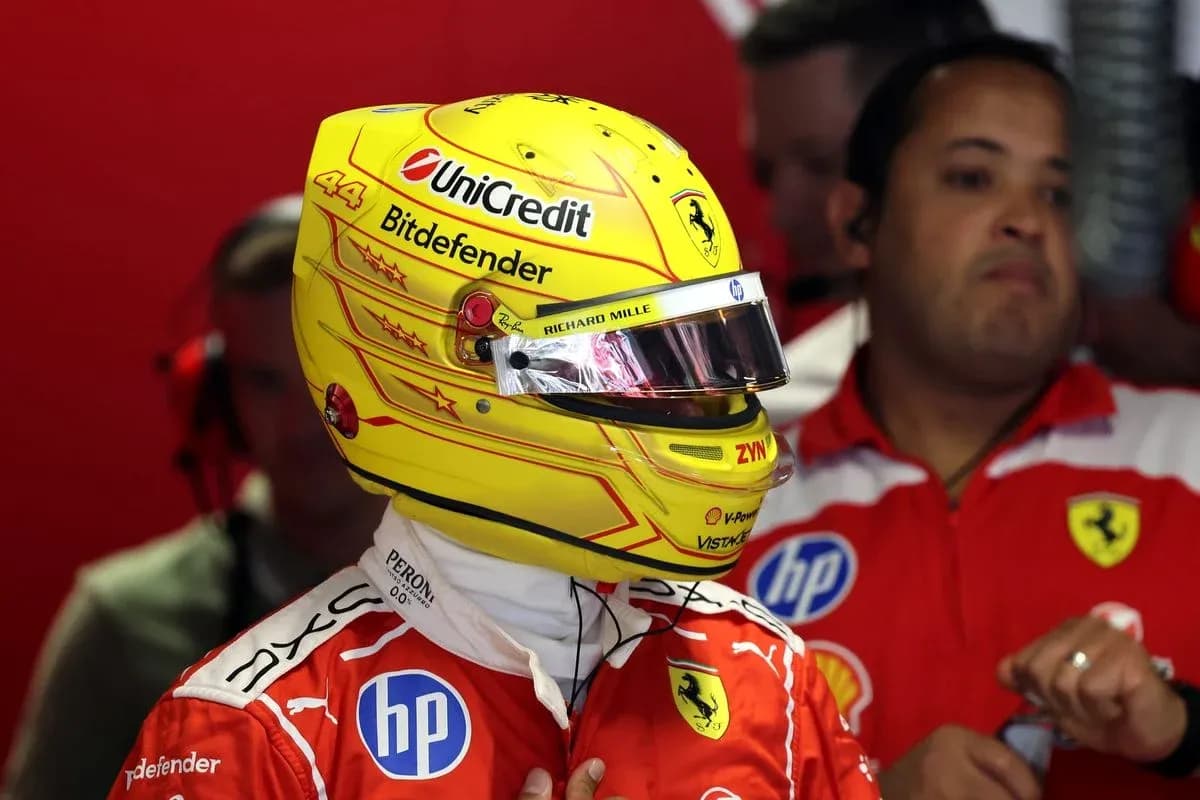 Driver wearing helmet in Ferrari pit garage Driver wearing helmet in Ferrari pit garage