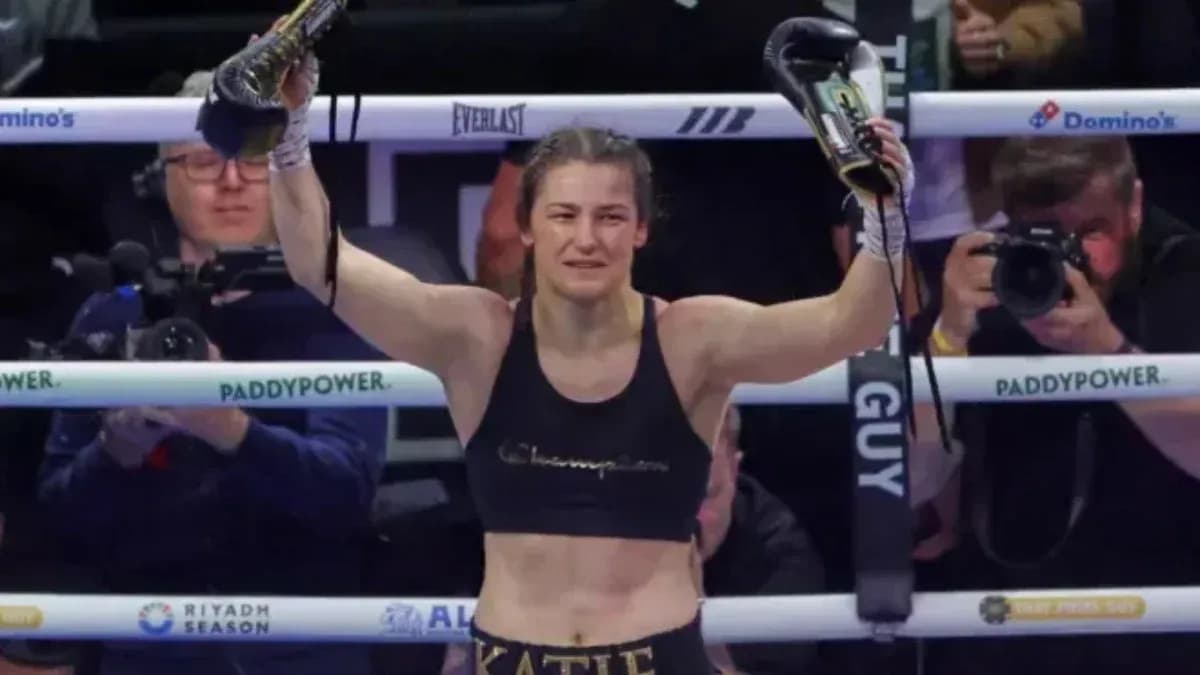 Boxer celebrating victory with gloves raised in ring Boxer celebrating victory with gloves raised in ring