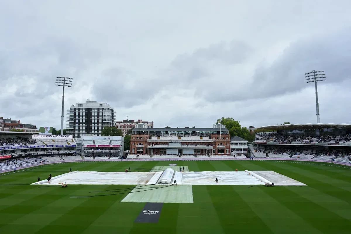 Cricket ground with covers during overcast weather Cricket ground with covers during overcast weather