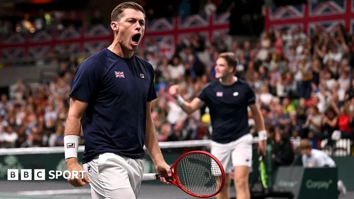 Player celebrating during a tennis match with crowd Player celebrating during a tennis match with crowd
