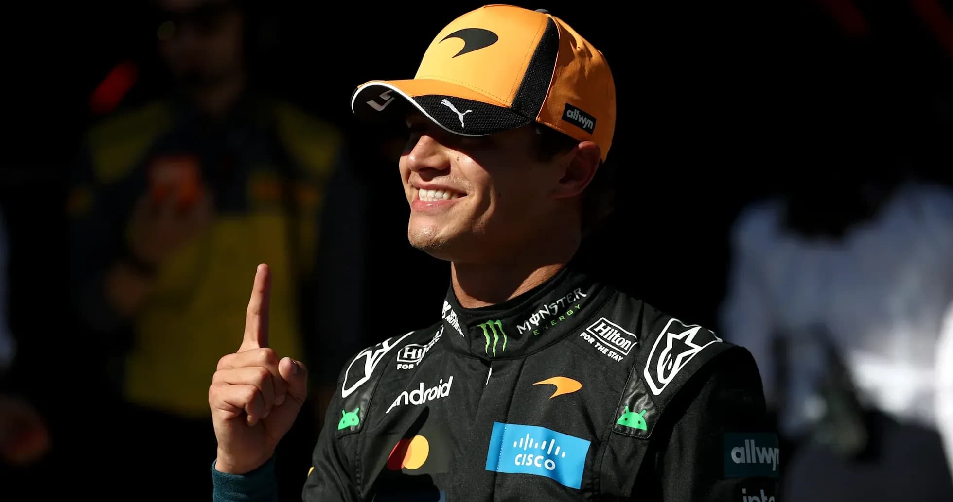 Driver celebrating with finger raised in pit area Driver celebrating with finger raised in pit area