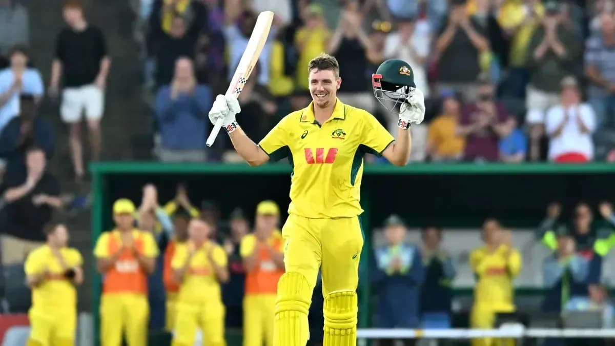 Cricketer celebrating a century with raised bat Cricketer celebrating a century with raised bat