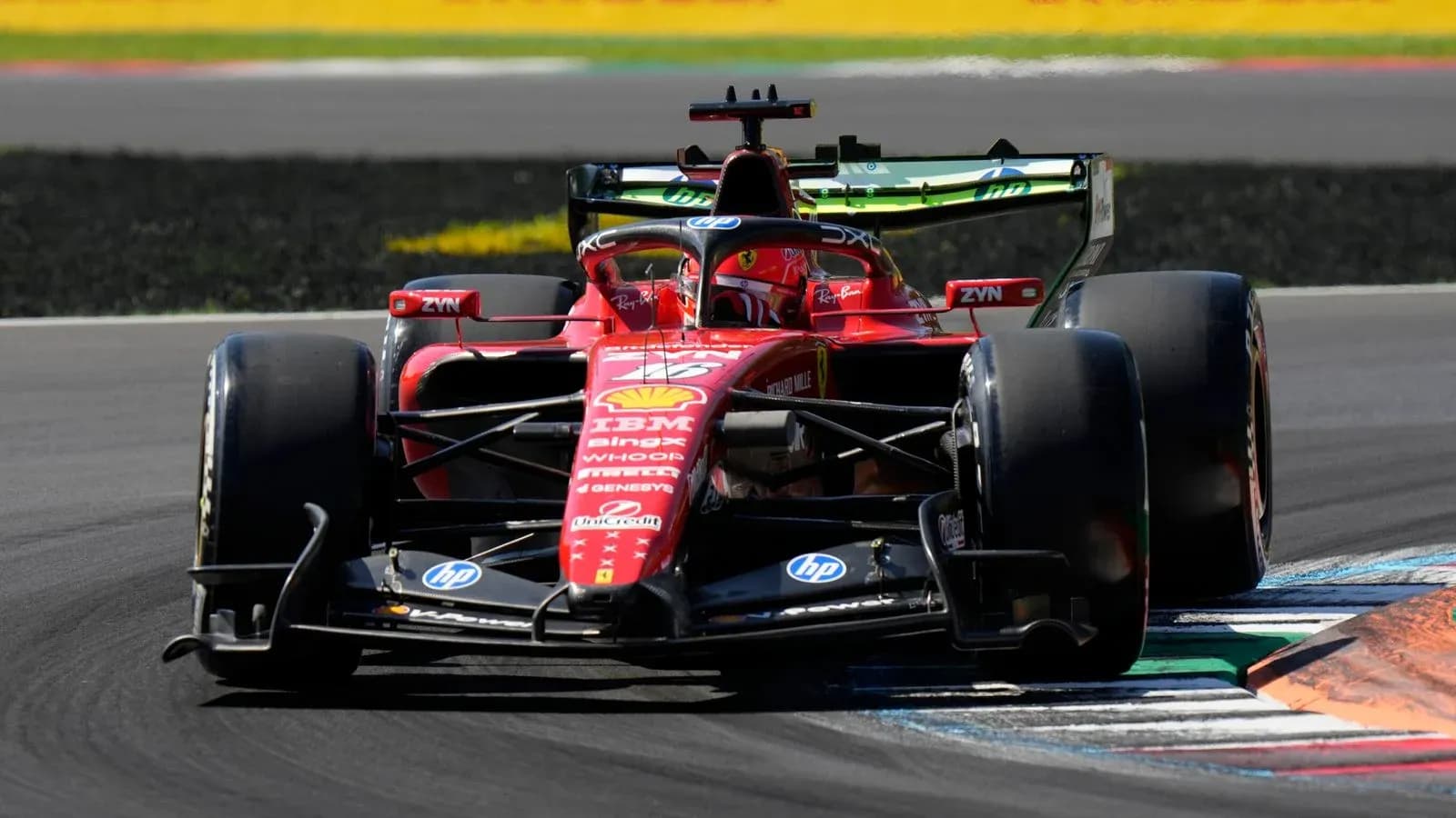 Ferrari F1 car navigating a track corner Ferrari F1 car navigating a track corner