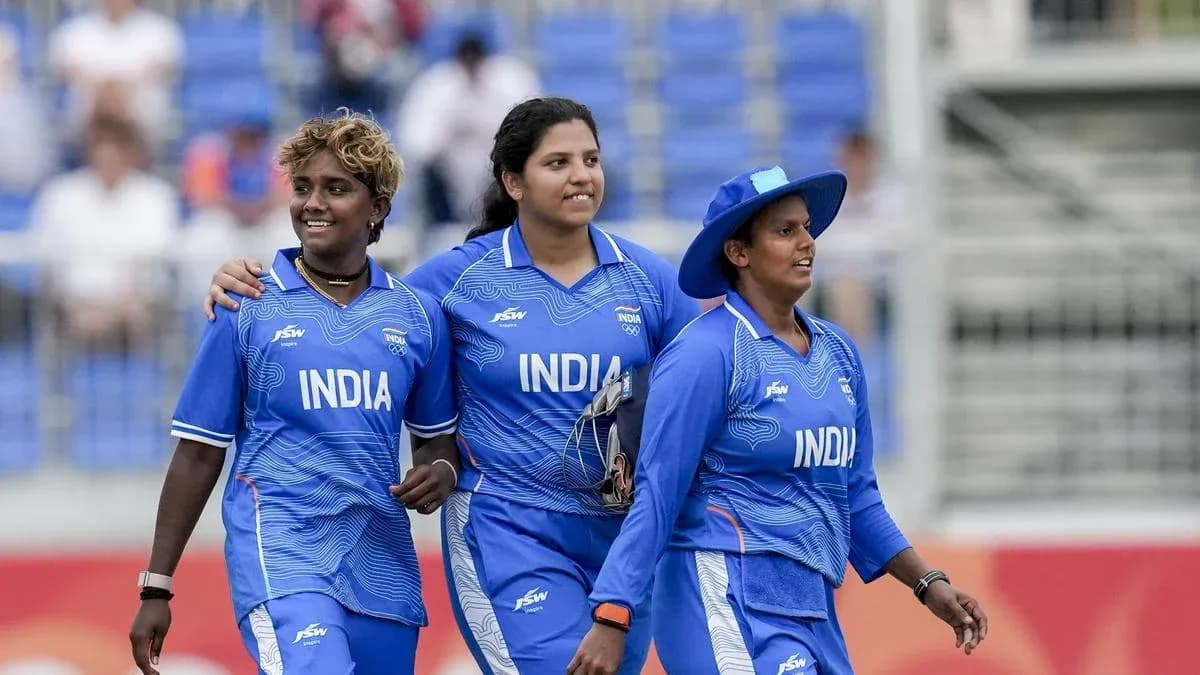 Three Indian women cricketers walking together on field Three Indian women cricketers walking together on field