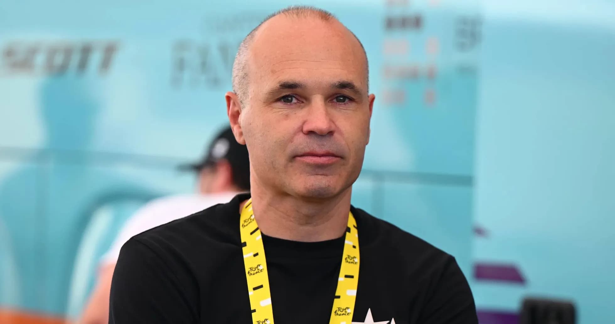 Man with a lanyard at a cycling event Man with a lanyard at a cycling event