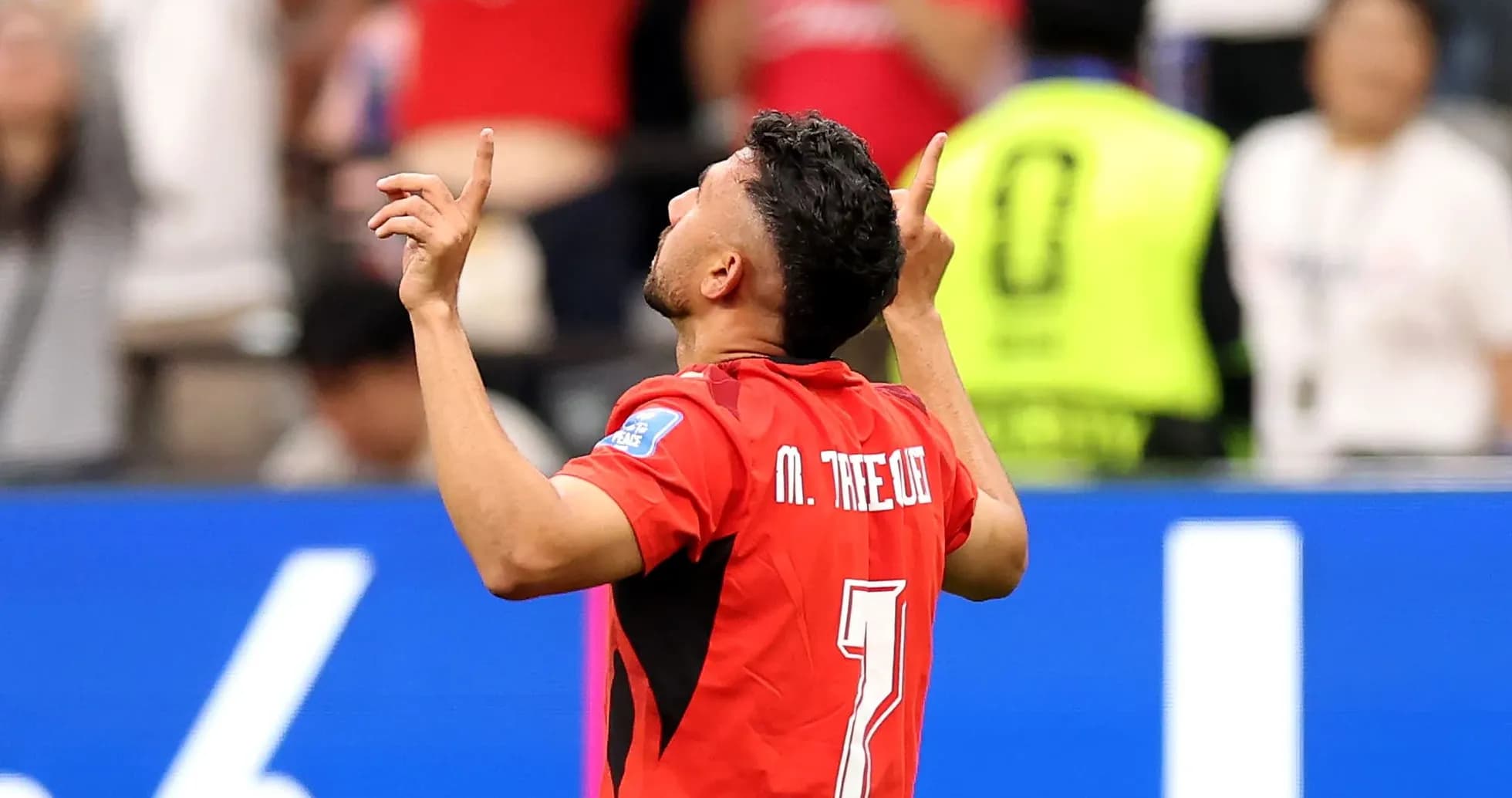 Player celebrating a goal with raised arms Player celebrating a goal with raised arms