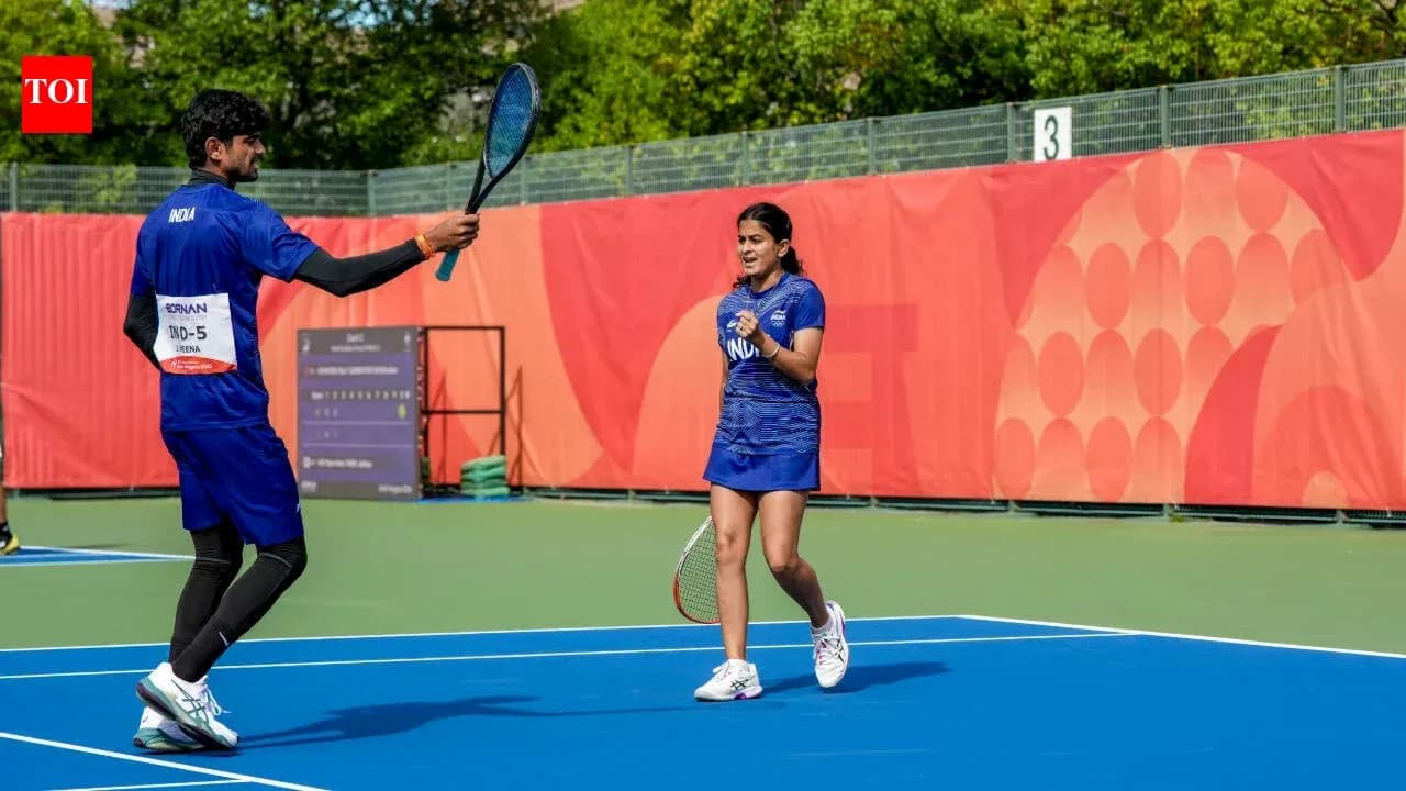 Two tennis players celebrating on court together Two tennis players celebrating on court together