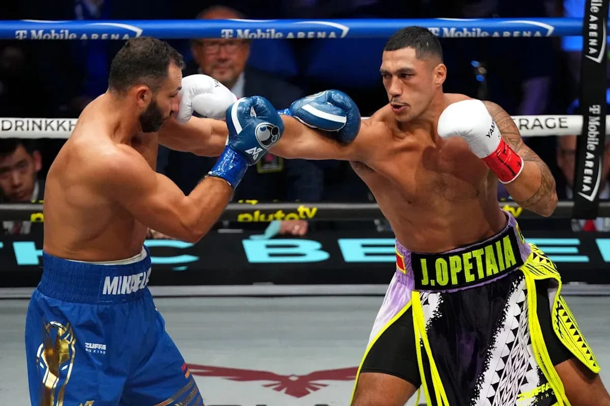 Two boxers exchanging punches in the ring Two boxers exchanging punches in the ring